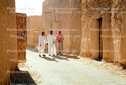 Men walking down the street, buildings, Saudi Arabia