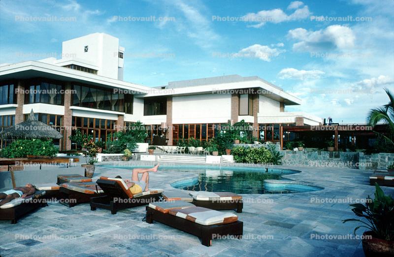 Hotel, swimming pool, lounge chairs, building, Mazatlan, Sinaloa, October 1976, 1970s