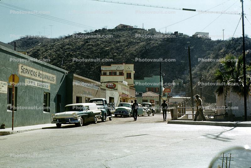 Cars, downtown, buildings, hill, 1950s