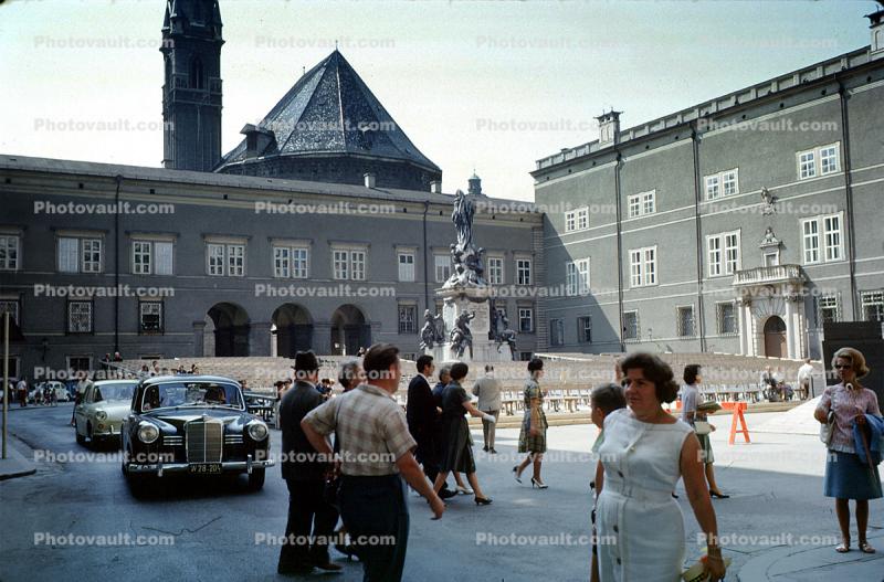 Statue, Cars, buildings, crowds, pedestrians, Salzburg, 1950s