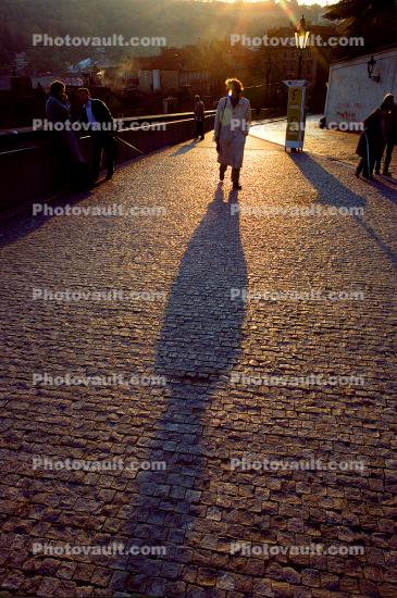 Person Walking, shadow, cobblestone street, Sunset, Sunclipse