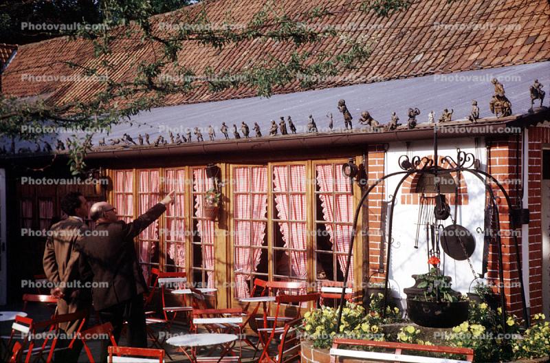 Figurines perched on the roofs edge, curtains, windows, restaurant, 1950s