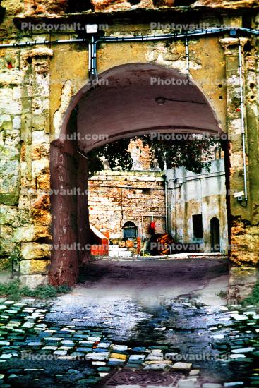 Archway, entry, cobblestone roadway, ruins