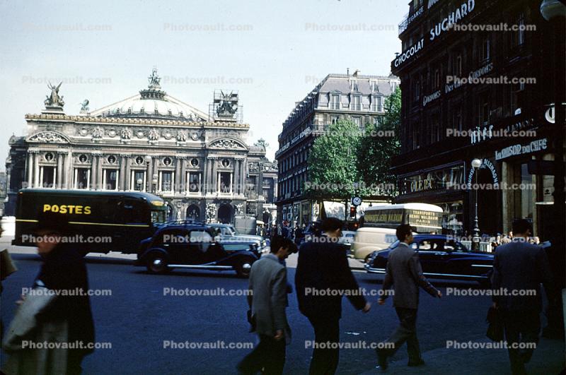 Postes, cars, buildings, people, 1940s
