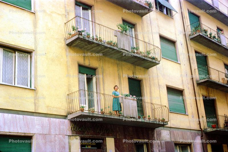 Woman standing on a balcony, May 1961