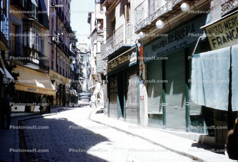 Cobblestone Street, sidewalk, buildings, shops, narrow street, 1940s