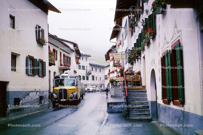Bus, wet narrow street, stairs, buildings, Switzerland