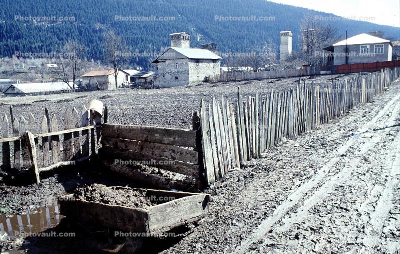 Fence, muddy road, buildings, valley, Svaneti, Caucasus Mountains