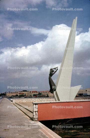 Curacao Monument to Victims of WWII, female sculpture, clouds, Willemstad