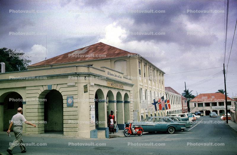 Western Union Building, Downtown Saint Croix, Cars, flags, Saint Croix, June 1965