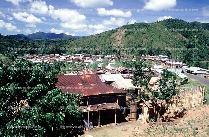 Village, rusty tin roof, buildings, homes, houses, mountains, jungle
