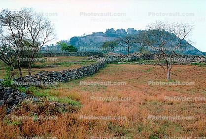 Great Zimbabwe Ruins, Stone Wall, fields, trees, mountain