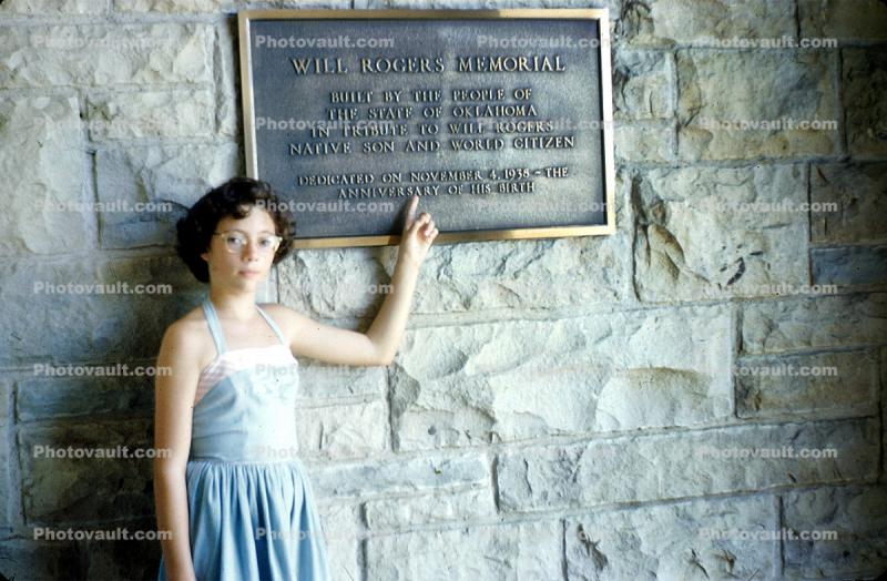 brass plaque, girl, woman, brick, landmark, Will Rogers Memorial, pointing, building, August 1952, 1950s