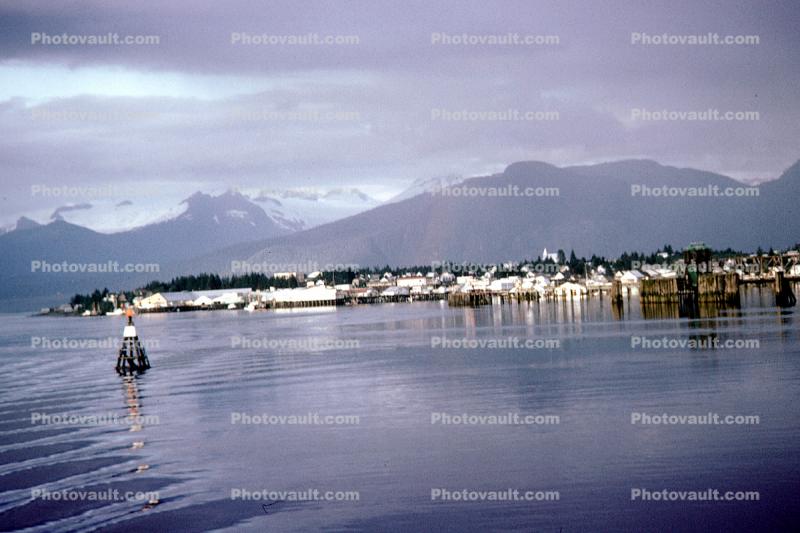 Harbor, boats, piers, Ketchikan Waterfront, skyline, city, town, mountains, placid water,  July 1969