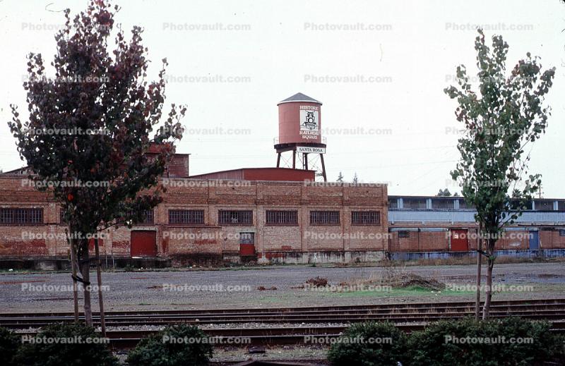 water tower, building, railroad tracks