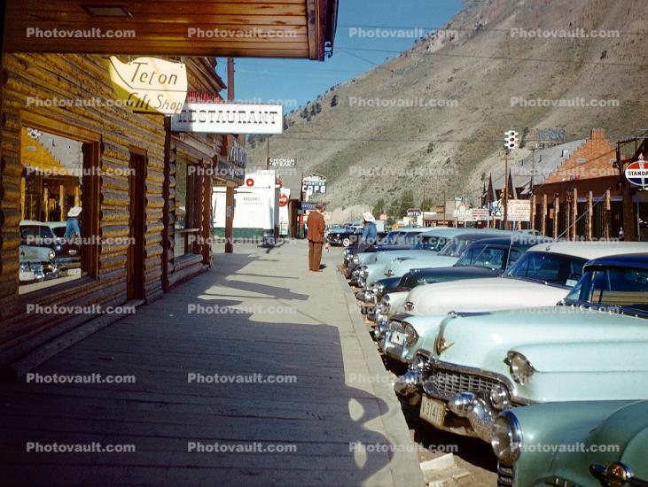 Parked Cars, Cadillac, Chevy, buildings, wooden boardwalk, Teton Village, 1950s