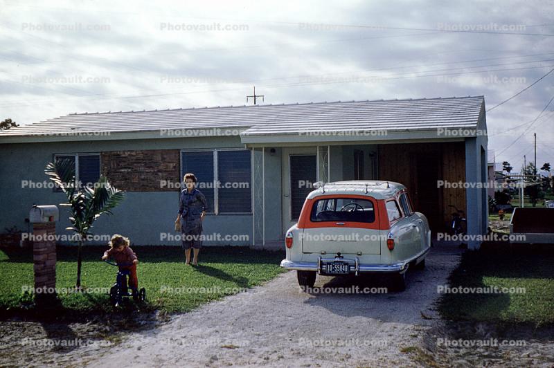 Nash Rambler, Garage, woman, girl on a tricycle, driveway, 1950s
