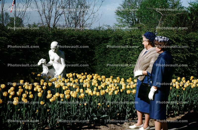 Gardens, flowers, path, people, statue, women, tulips, fur coat, shawl, hats, gloves, 1940s