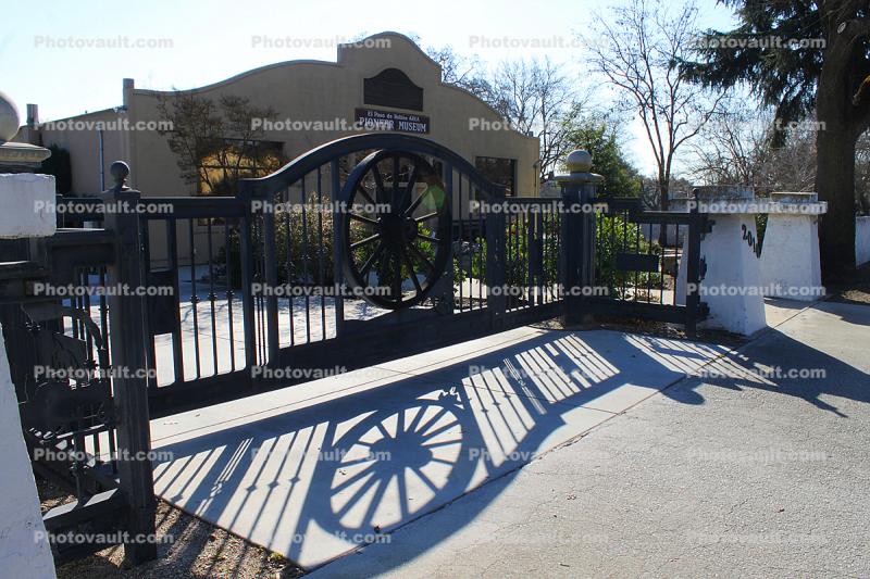 wagon wheel, shadow, gate, Paso Robles History Museum