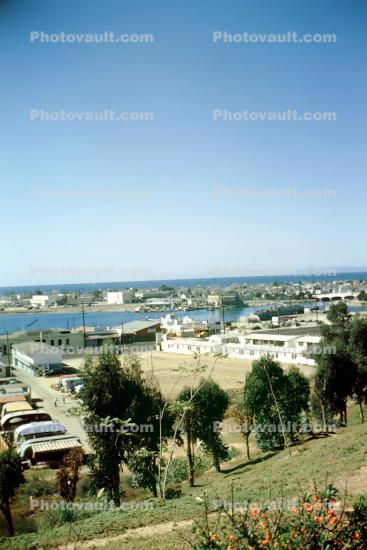 Newport Harbor, Catalina Island in background, trailer park, 1950s