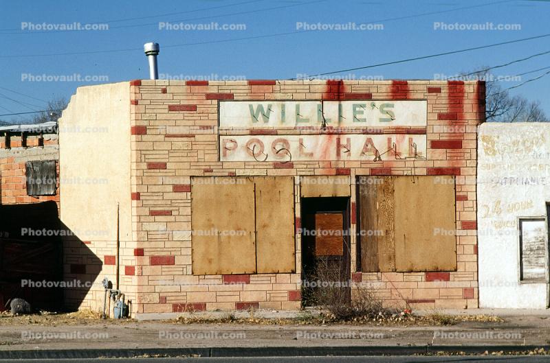 Willie's Pool Hall no more, boarded up building, brick