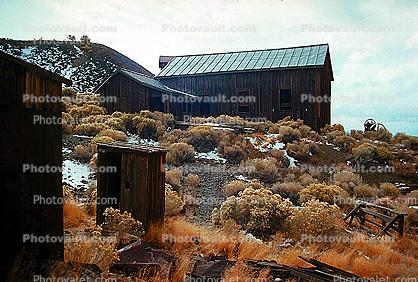Creosote bush, desert shrub, buildings, hillside, barn, outhouse, shack