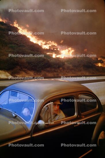 Man in a Volkswagen Beetle, Fire, 1950s