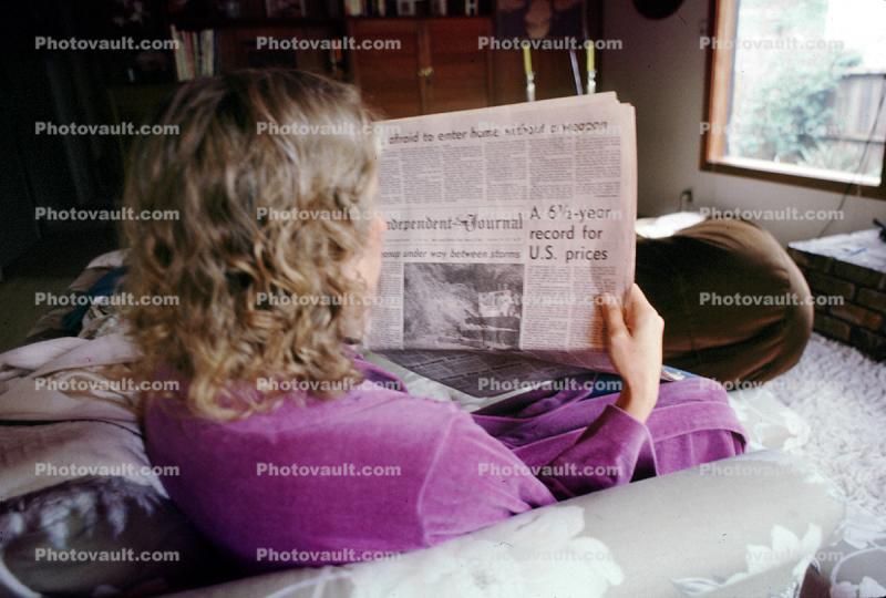 Woman reads the morning newspaper