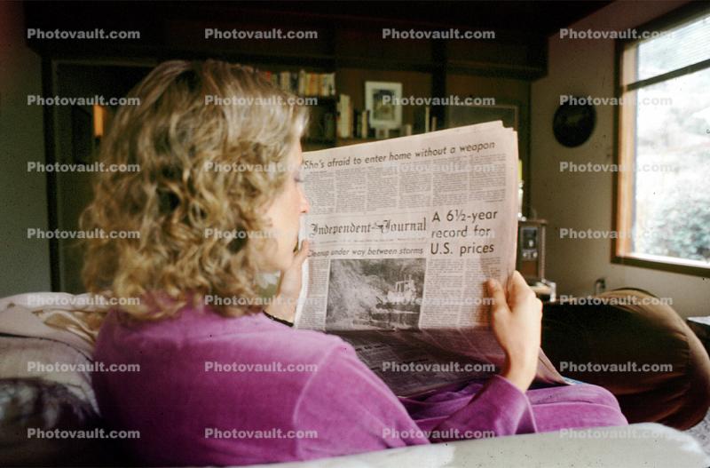 Woman reads the morning newspaper