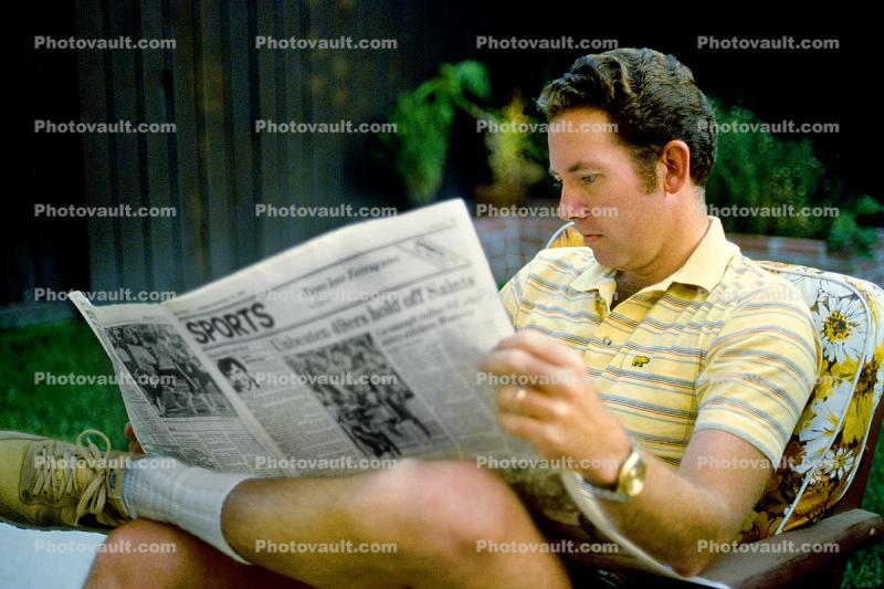Man reading the Sports Page