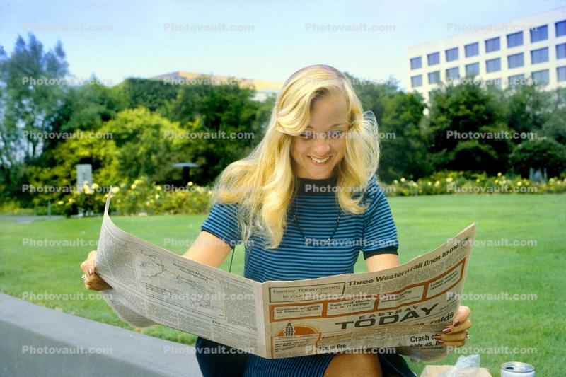 Woman, Smiles Reading the Newspaper