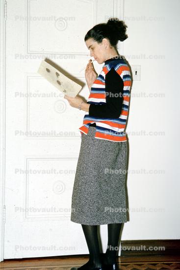 Woman Reading a Magazine Standing