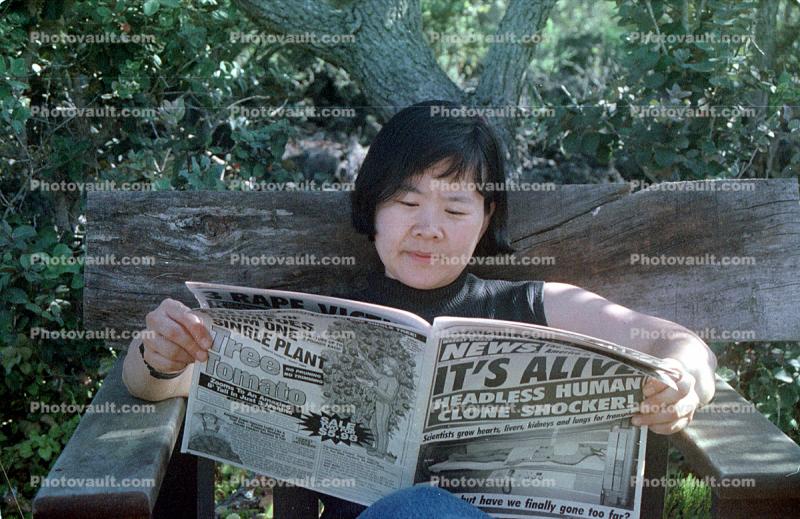 Woman reads a Tabloid, It's Alive