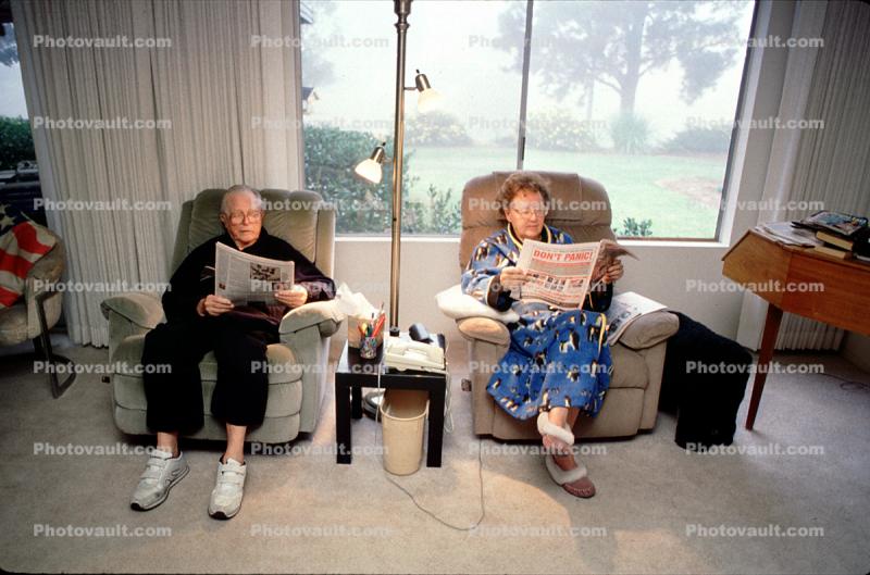 Couple reading the morning newspaper