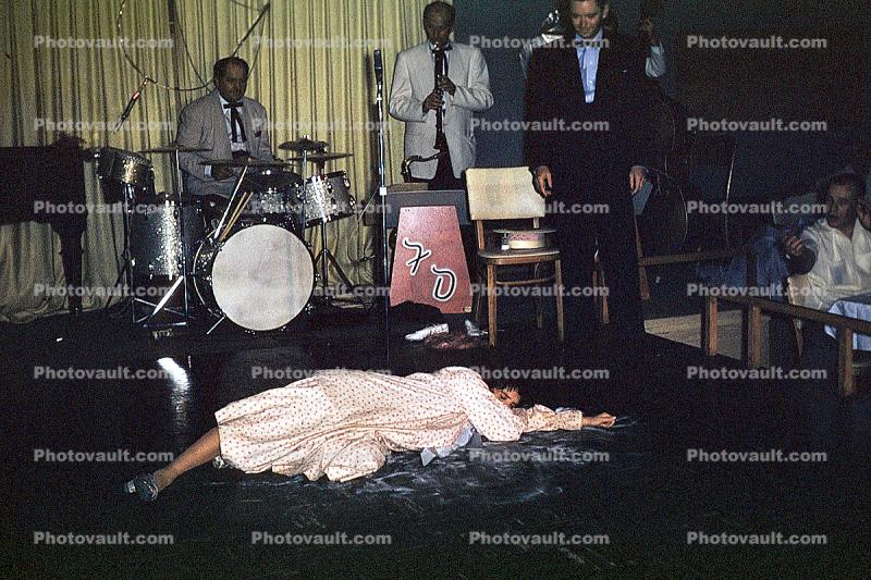 Woman laying down on stage