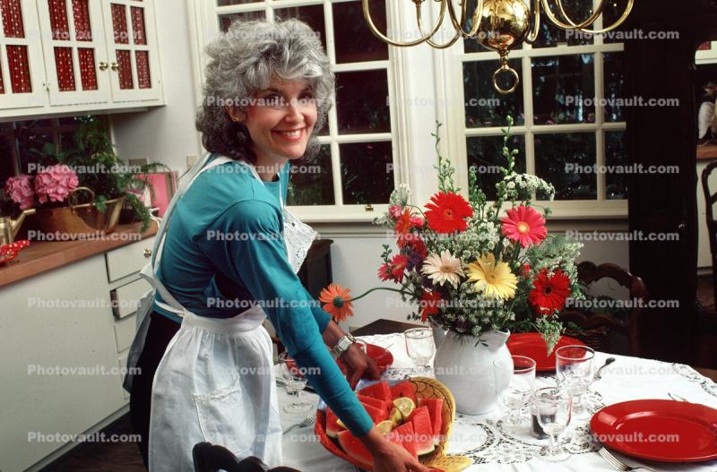 Woman Setting a Watermelon Plate on the Table, Smile