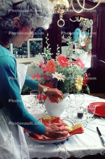 Woman Setting a Watermelon Plate on the Table+