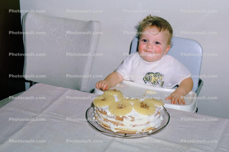 Smilling baby, toddler, pineapple cake, bib, smiles, cute, highchair, messy, 1970s