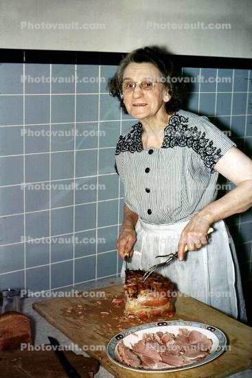 Grandma, grandmother, woman, slicing meat, roast, cooked, plate, cutting, 1940s