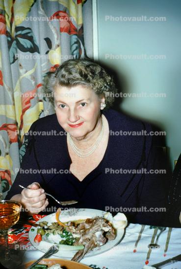 Dinner, woman, table setting, plate, smiles, eating, 1940s