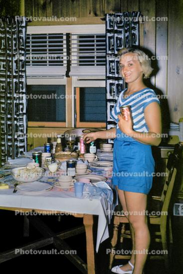 Woman, table setting, plates, dinner, window, curtains, 1950s