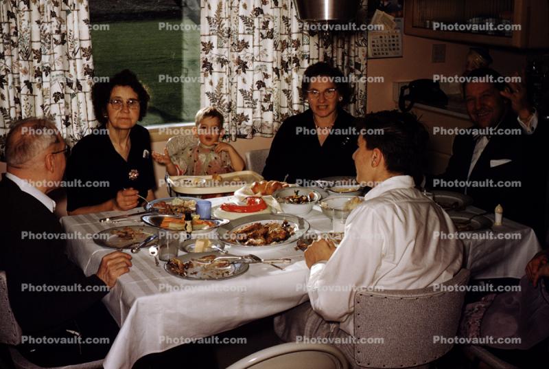 1950s, Holiday Dinner. Women, Men, couples, Mouth full, Table Cloth