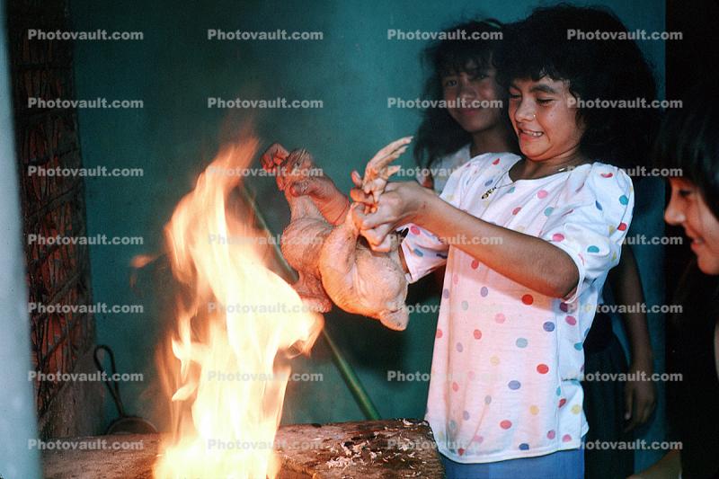Girl Roasting a chicken, Chicken Slaughterhouse, San Salvador, El Salvador