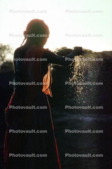 Woman processing wheat, Gujarat, India