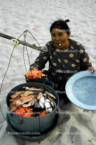 Woman selling Crabs, shellfish, smoking, Beach, Nha Trang, Vietnam