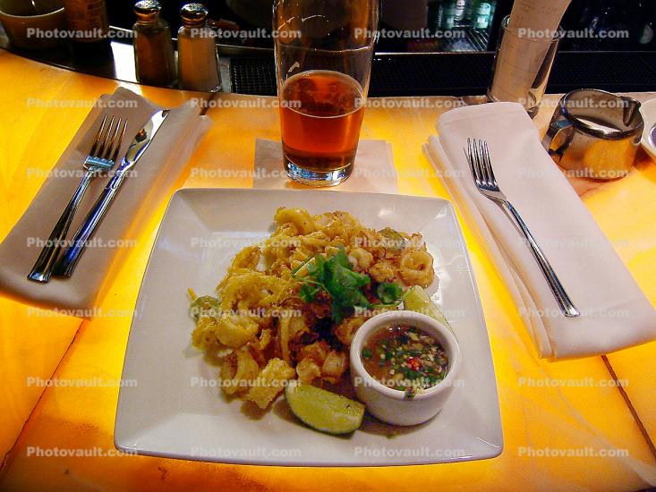 Fried Calamari, fork, knife, beer, napkin