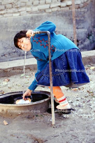 Girl, water well, Samarkand, Uzbekistan