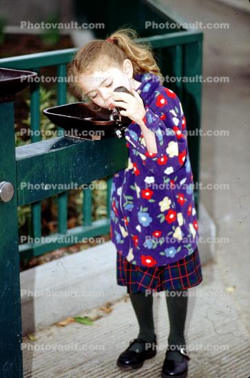 Girl drinking from a Water Fountain, aquatics