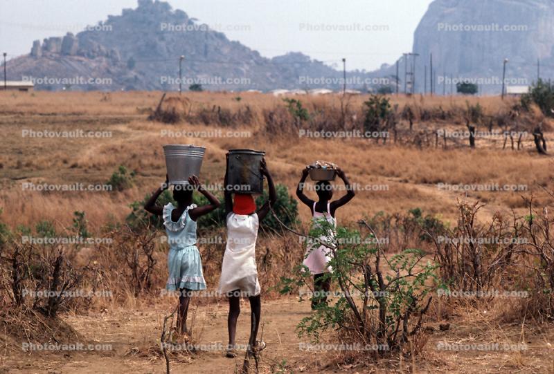 Girls Carrying water back to the village, Child-Labor