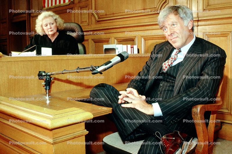 Defendant, witness stand, male, businessman, man, microphone, person, Pinstripe Suit, tie, People, talking, speaking, smile, court session, trial, Woman Judge